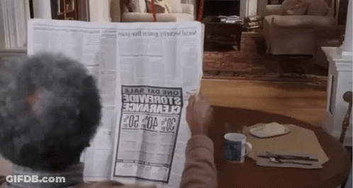 A Man Is Reading A Newspaper With A Headline That Says 30 GIF