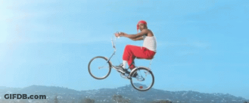 A Man Is Riding A Bicycle In The Air GIF