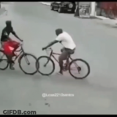 A Man Is Riding A Bike Next To A Woman On A Bike GIF