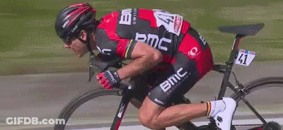 A Man Is Riding A Bike With The Number 41 On The Back Of His Jersey GIF