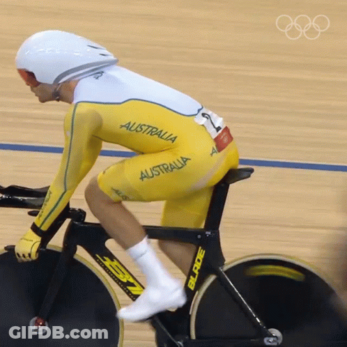 A Man Is Riding A Bike With The Word Australia On His Outfit GIF