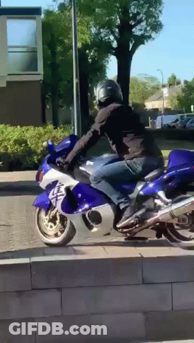 A Man Is Riding A Blue And White Motorcycle With Chinese Characters On The Front GIF