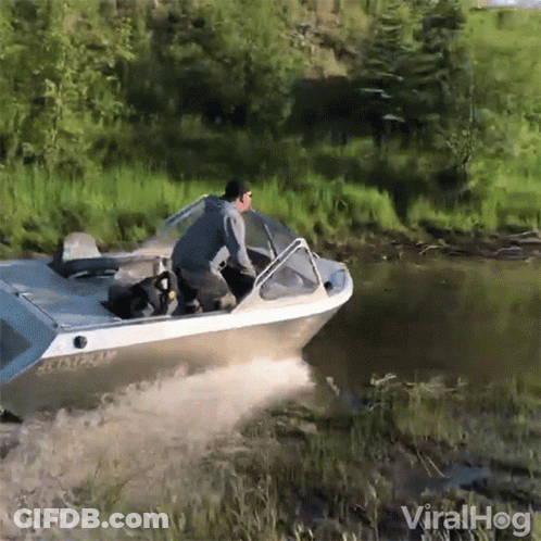 A Man Is Riding A Boat In A River With The Words Viralhog In The Corner GIF