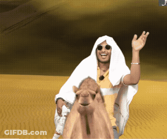 A Man Is Riding A Camel In The Desert GIF