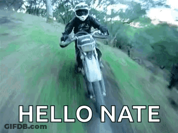 A Man Is Riding A Dirt Bike Down A Dirt Road And The Words `` Hello Nate '' Are Visible . GIF