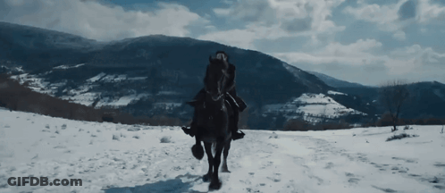 A Man Is Riding A Horse In The Snow GIF