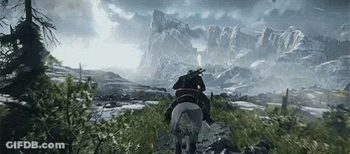 A Man Is Riding A Horse Through A Snowy Mountainous Area GIF