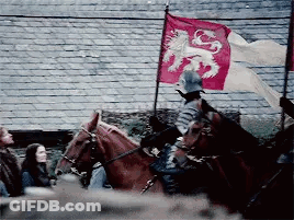 A Man Is Riding A Horse With A Red Flag With A Lion On It . GIF