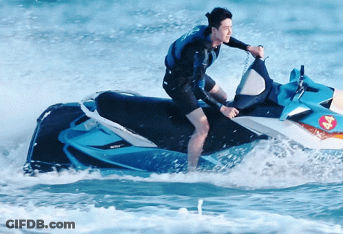 A Man Is Riding A Jet Ski In The Ocean With A Sticker On The Back That Says ' Jet Ski ' GIF