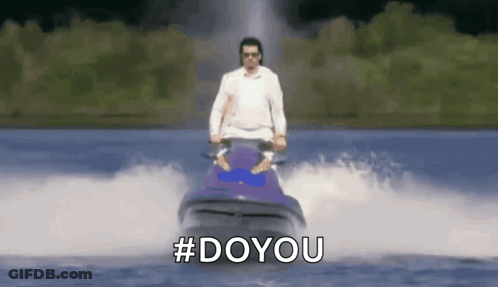 A Man Is Riding A Jet Ski In The Water With The Hashtag #Doyou . GIF