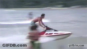 A Man Is Riding A Jet Ski On A Body Of Water GIF