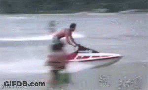 A Man Is Riding A Jet Ski On The Water . GIF