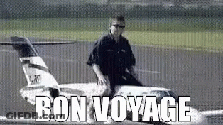 A Man Is Riding A Model Airplane On A Runway And The Words Bon Voyage Are Above Him . GIF