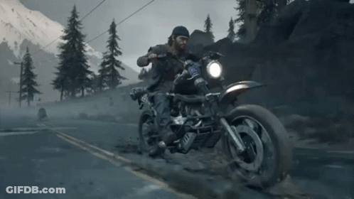 A Man Is Riding A Motorcycle Down A Road With Mountains In The Background And A License Plate That Says ' A ' GIF