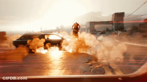 A Man Is Riding A Motorcycle On A Street With Smoke Coming Out Of It GIF