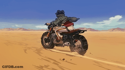 A Man Is Riding A Motorcycle Through The Desert GIF