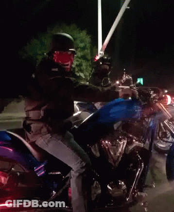 A Man Is Riding A Motorcycle With A Blue Tank GIF