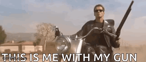 A Man Is Riding A Motorcycle With A Gun In His Hand And The Words `` This Is Me With My Gun '' . GIF