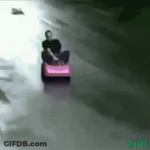 A Man Is Riding A Pink Lawn Mower With The Word Drift On The Bottom GIF