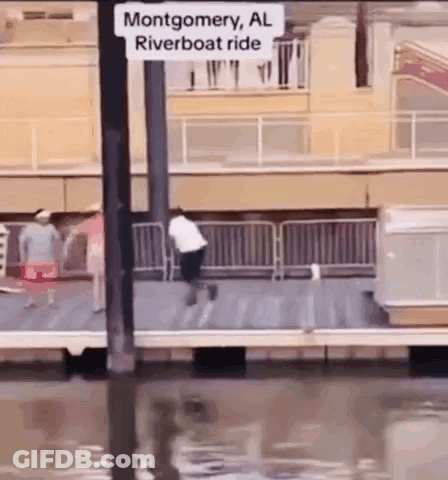 A Man Is Riding A Riverboat In Montgomery Al . GIF