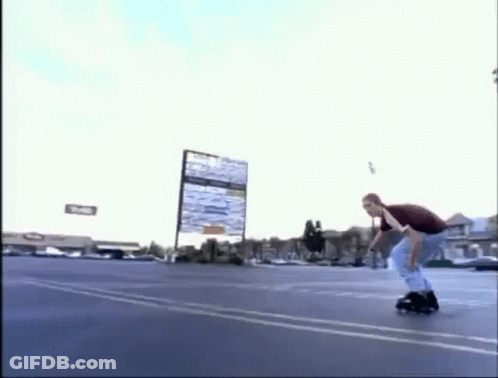 A Man Is Riding A Roller Skate In A Parking Lot While Holding A Sign . GIF