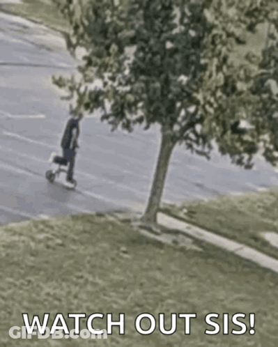 A Man Is Riding A Scooter Down A Street With The Words `` Watch Out Sis '' Written On The Bottom . GIF