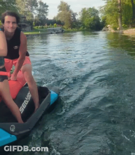 A Man Is Riding A Sea Doo Jet Ski In The Water GIF