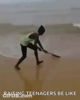 A Man Is Riding A Wave On A Surfboard On The Beach With The Words `` Raising Teenagers Be Like '' . GIF