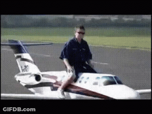 A Man Is Riding On The Back Of A Small Airplane With The Numbers N70 On The Tail GIF