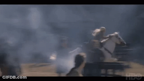 A Man Is Riding On The Back Of A White Horse In A Smokey Area . GIF