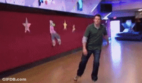 A Man Is Rollerblading In A Bowling Alley With Stars On The Wall GIF