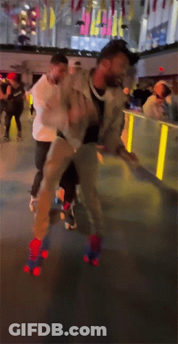 A Man Is Rollerblading On A Rink With A Crowd Behind Him GIF