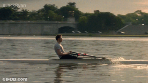 A Man Is Rowing A Boat On A Lake With #Jackryan Written Above Him GIF