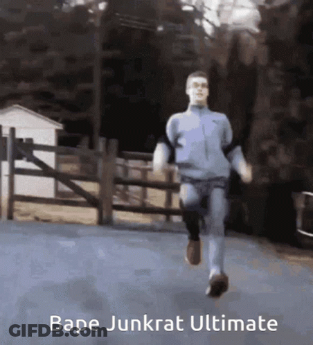 A Man Is Running Down A Road With The Words Bape Junkrat Ultimate On The Bottom GIF
