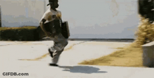 A Man Is Running Down A Sidewalk Carrying A Briefcase GIF