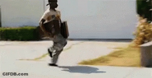 A Man Is Running Down A Sidewalk Carrying A Skateboard . GIF