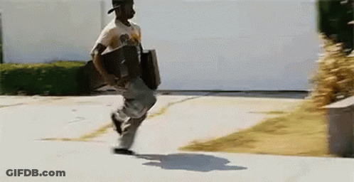 A Man Is Running Down A Sidewalk With A Briefcase In His Hand GIF