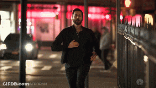 A Man Is Running Down A Street With The Hashtag #Newamsterdam On The Bottom GIF
