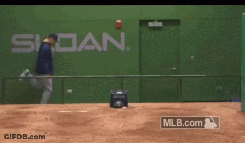 A Man Is Running On A Baseball Field In Front Of A Wall That Says Siddan GIF