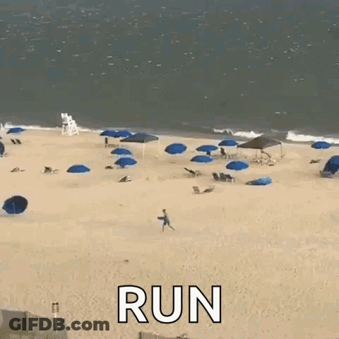 A Man Is Running On A Beach With The Words Run Written On The Sand . GIF