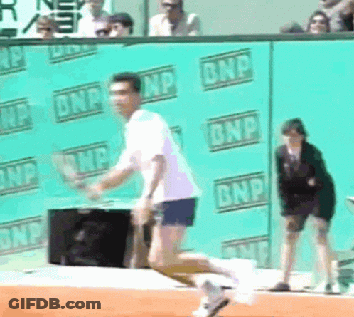A Man Is Running On A Tennis Court In Front Of A Wall That Says Bnp GIF