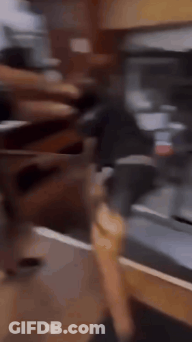 A Man Is Running On A Treadmill In Front Of A Refrigerator While Another Man Watches . GIF