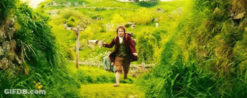 A Man Is Running Through A Grassy Field With A Backpack On His Back . GIF