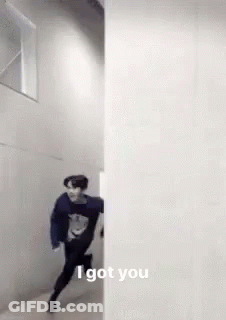 A Man Is Running Through A Hallway Next To A Wall And Says `` I Got You '' . GIF