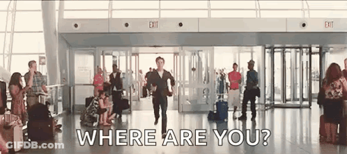 A Man Is Running Through An Airport With A Suitcase And Asking Where Are You . GIF