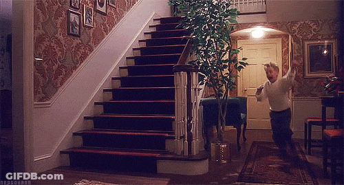 A Man Is Running Up A Set Of Stairs In A Home GIF