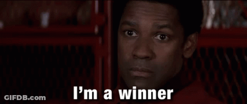 A Man Is Saying `` I 'M Going To Win '' While Standing In Front Of A Red Fence . GIF