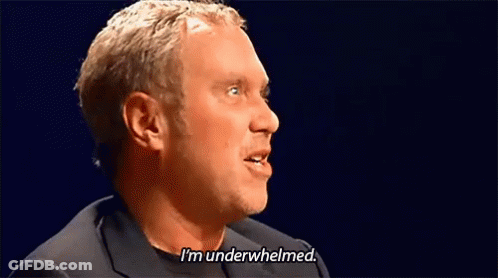 A Man Is Saying I 'M Underwhelmed In A Dark Room . GIF