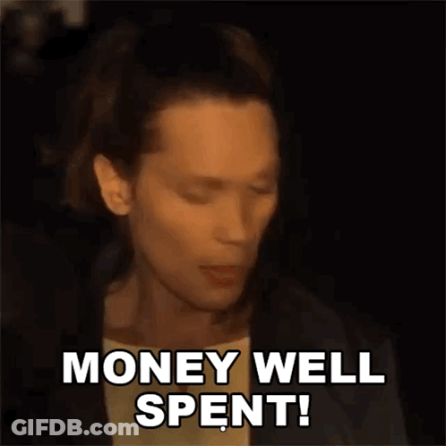 A Man Is Saying Money Well Spent In A Dark Room GIF