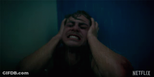 A Man Is Screaming In A Shower With A Netflix Logo Behind Him GIF